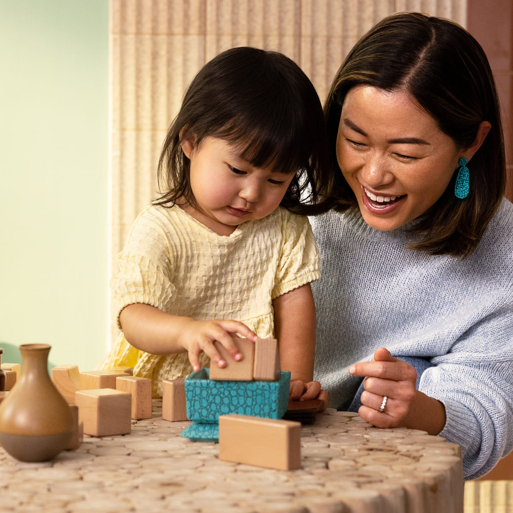 Mom and daughter play with building blocks